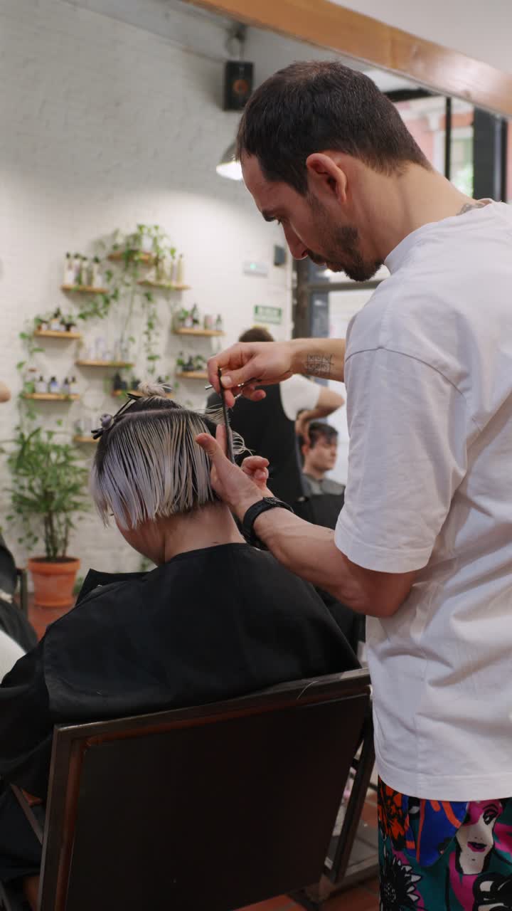 Hairdresser giving a haircut