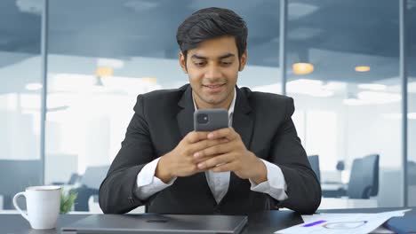 Happy-Indian-entrepreneur-using-mobile-phone
