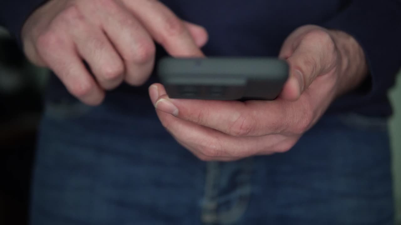 Person Using Phone and Puts it in his Jeans Pocket, Close up, no Face