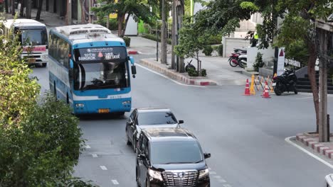 various vehicles navigating a busy bangkok street