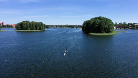 AERIAL:-Lone-and-Isolated-Paddling-Canoe-with-Athletes-on-the-Surface-of-the-Lake-Calmly-Sailing-in-Between-Buoy-Marked-Lines