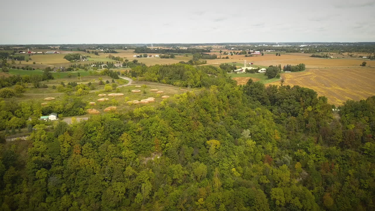 Cinematic drone shot of large farming fields in the countryside