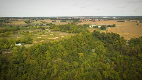 Cinematic-drone-shot-of-large-farming-fields-in-the-countryside