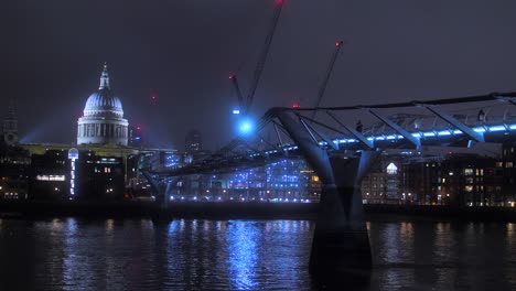 people walking on millennium bridge with st