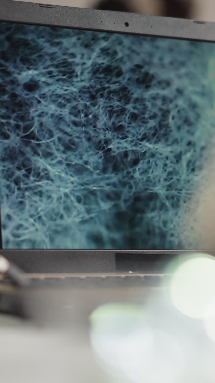 Learning structure of researched test bio-material sample with microscope close view on laptop screen at experiment in scientific laboratory