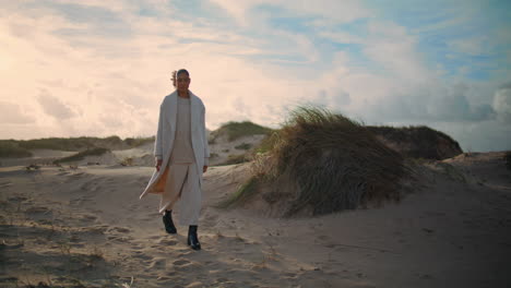 Girl-traveler-going-beach-dunes-on-weekend-trip.-Serene-woman-admire-wild-nature