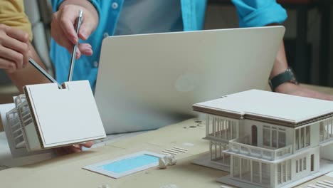 architects collaborating on a house model