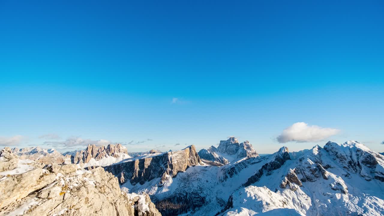 밤에 떠오르는 보름달과 함께 눈 덮인 몬테 펠모 산 위에 아름다운 황금빛 일몰의 저속 촬영