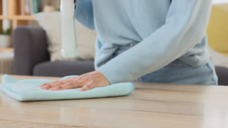 woman wiping a table at home