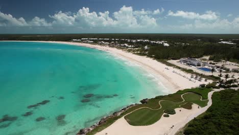 aerial view of scenic resort  with white sand beach and turquoise ocean in bahamas - drone shot