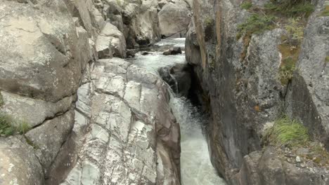 Aerial-view-of-river-and-waterfall-in-a-canyon-outside-Fort-Collins,-CO-at-the-end-of-summer