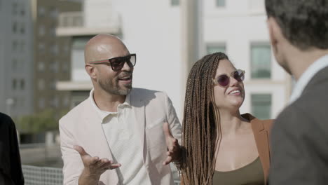 slow motion of happy employees standing on rooftop and talking