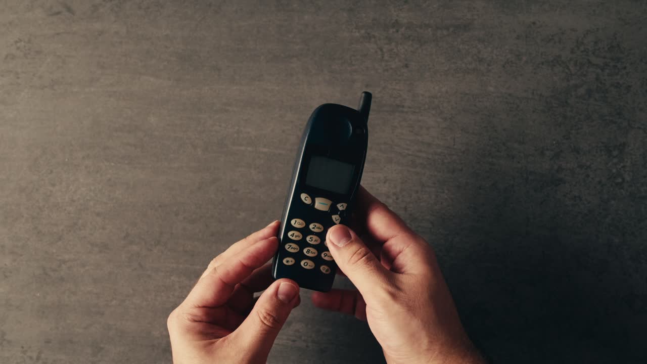 Old Mobile Phone in Hands