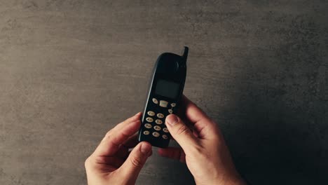 telemóvel velho nas mãos