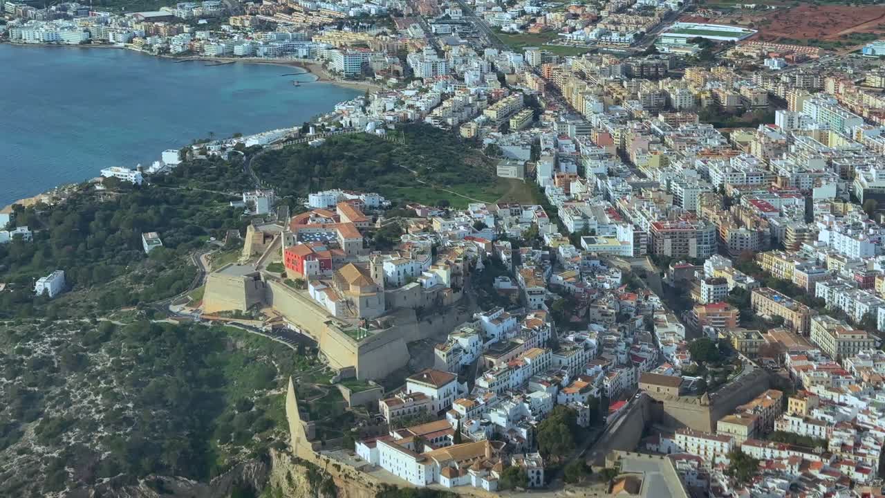 Elevated aerial view of Ibiza old town, with a view of the Castle and cathedral, captured from an airplane cockpit