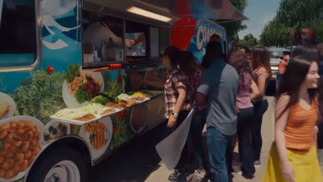 people ordering and receiving food from a food truck