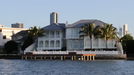 time-lapse of a large house by the water at sunset