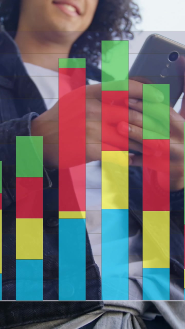 Animation of colourful graph over smiling man using smartphone in street