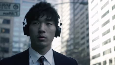 a solitary journey through the city: a young man in formal attire with headphones, embodying focus and determination amidst urban life