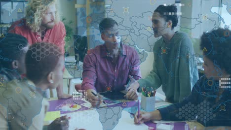 Animation-of-world-map-against-diverse-colleagues-discussing-over-a-documents-at-office