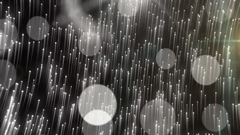 animatie van witte vallende sterren en bokeh lichtvlekken die zich op een zwarte achtergrond bewegen