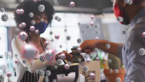animation of virus cells over diverse people wearing face masks