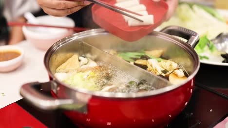 preparing hotpot with fresh ingredients in bangkok