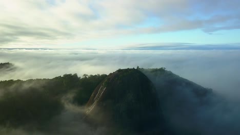 voltzberg granite dome mountain in misty suriname jungle rainforest, aerial view