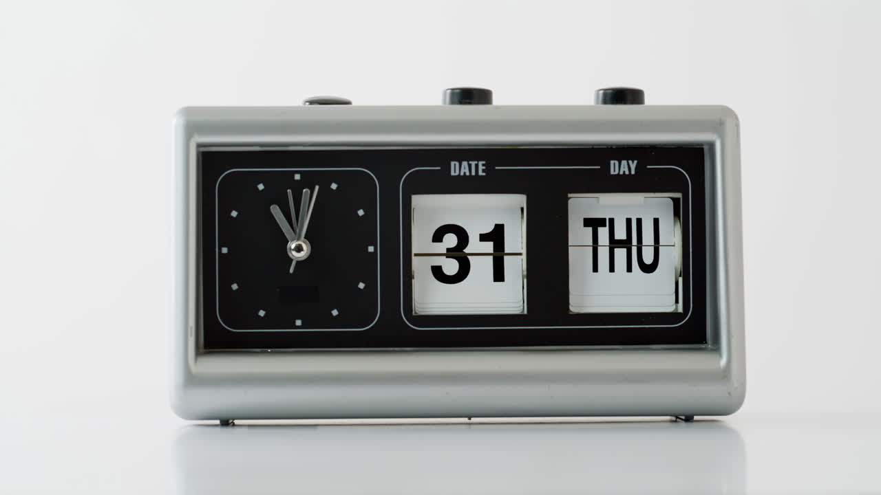Closeup flip clock showing date time at white background. Retro vintage device