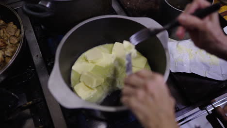 good portion of butter in a container for preparing bagna cauda