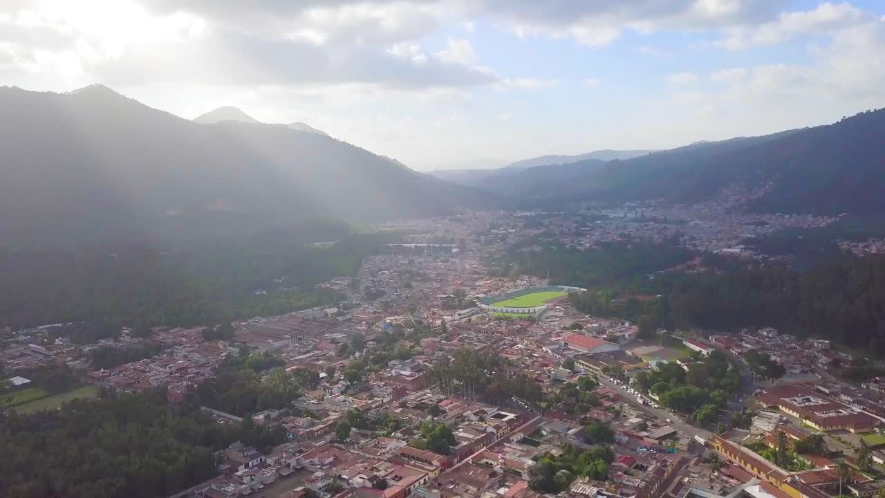 Antigua Guatemala City in a sunny day with a landscape of the volcano and mountains.
