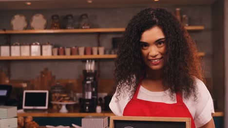 Smiling-waitress-showing-slate-with-open-sign