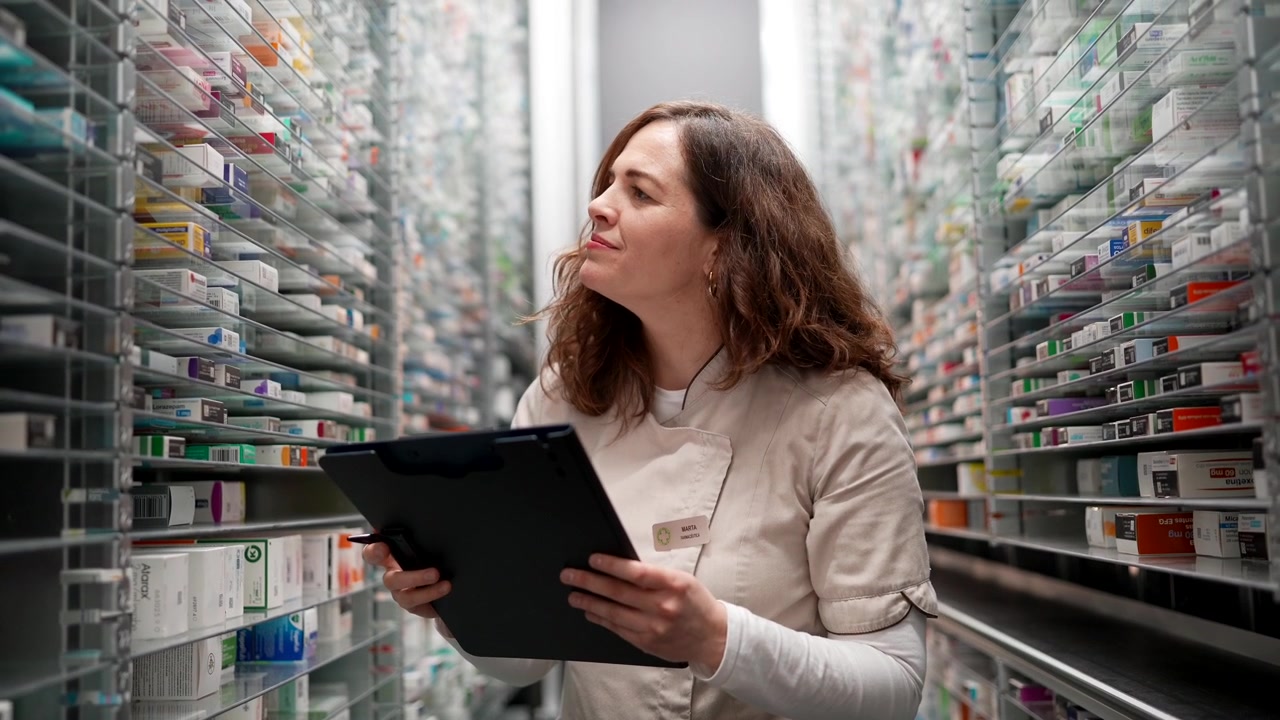 Pharmacist Checking Inventory in Pharmacy Stockroom