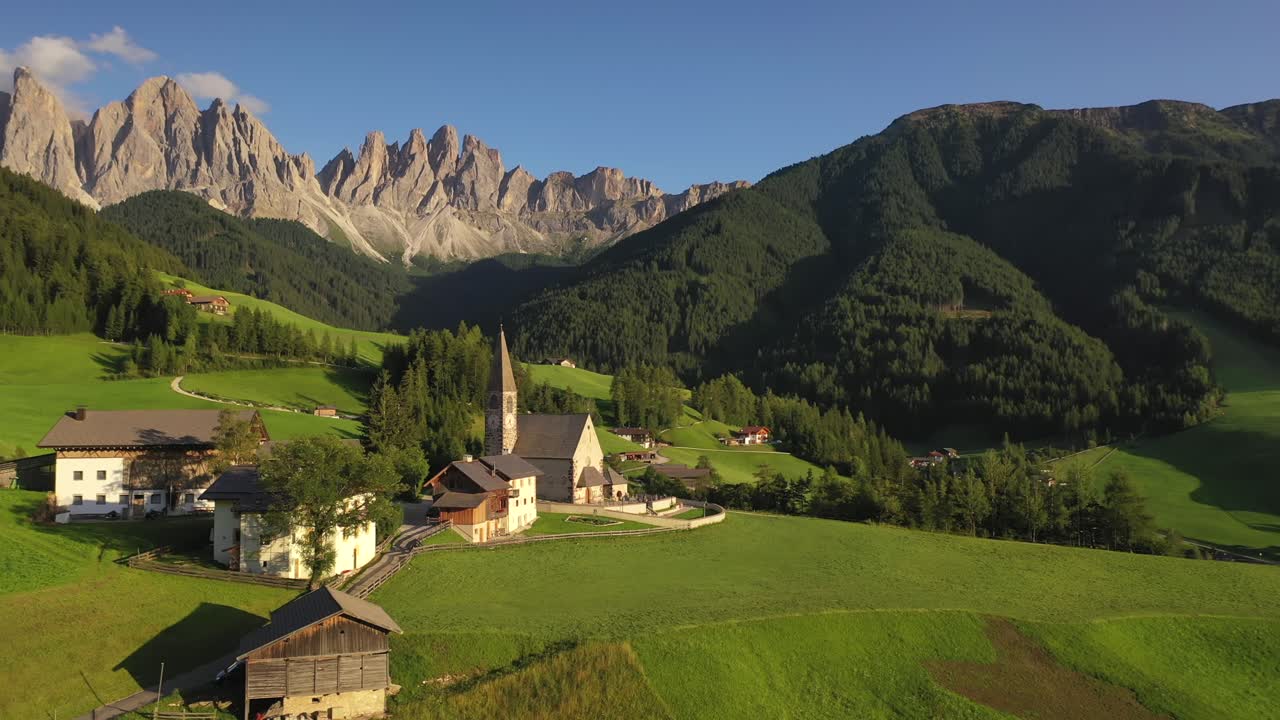 Santa Maddalena church with Odle mountain range in summer, aerial slow circle shot