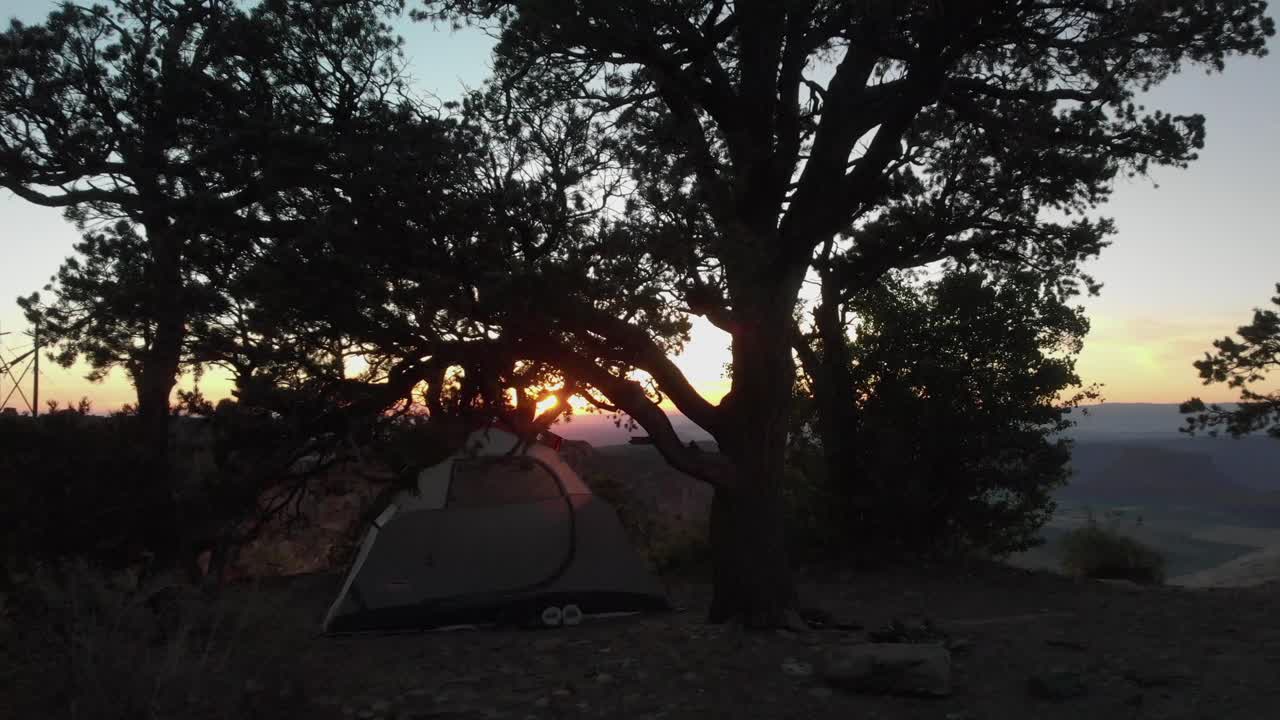 Low aerial: Porcupine Rim campsite tent with spectacular summer sunset