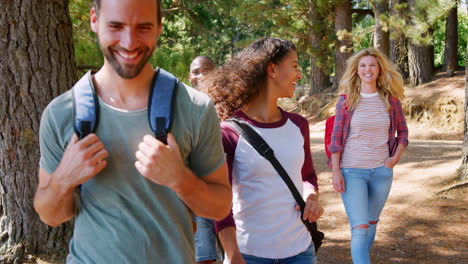group of young friends on hiking adventure in countryside