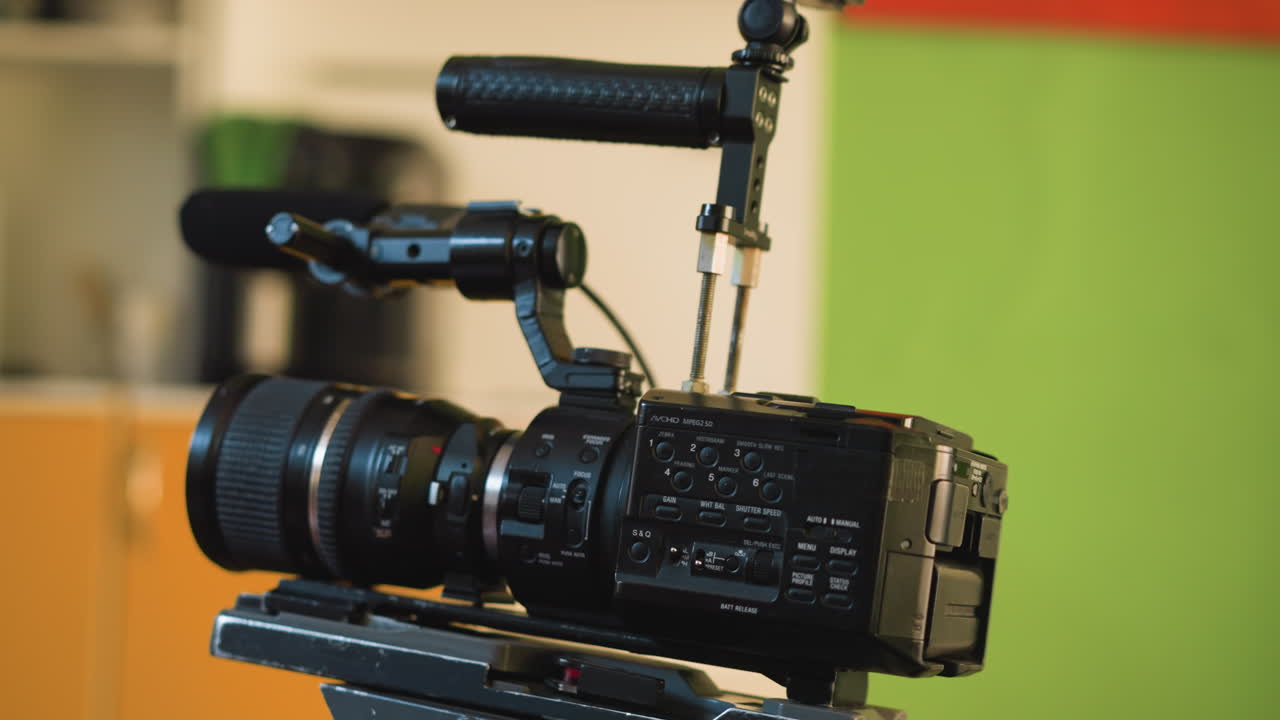 cameraman adjusting camera on tripod, focusing lens and setting up professional equipment for video production in studio, hand adjusting controls for smooth camera movement during shot