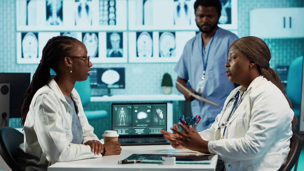 Black medical staff and patient discussing diagnostic feedback and records