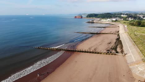 calm waves hitting empty dawlish warren beach in south devon