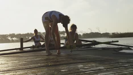 female rowing team training on a river