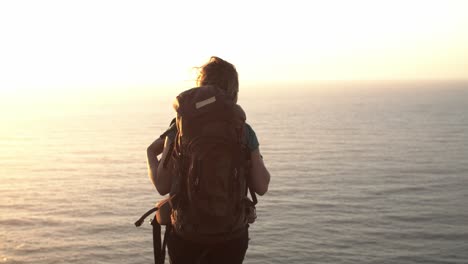 Excited-middle-aged-woman-wearing-camping-backpack