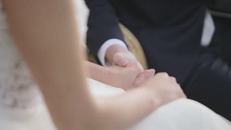 man and woman on wedding garments and holding hands
