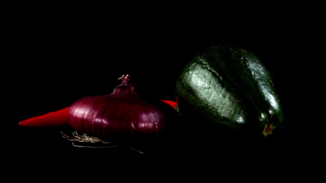 Avocado, onions and chili pepper on a black background
