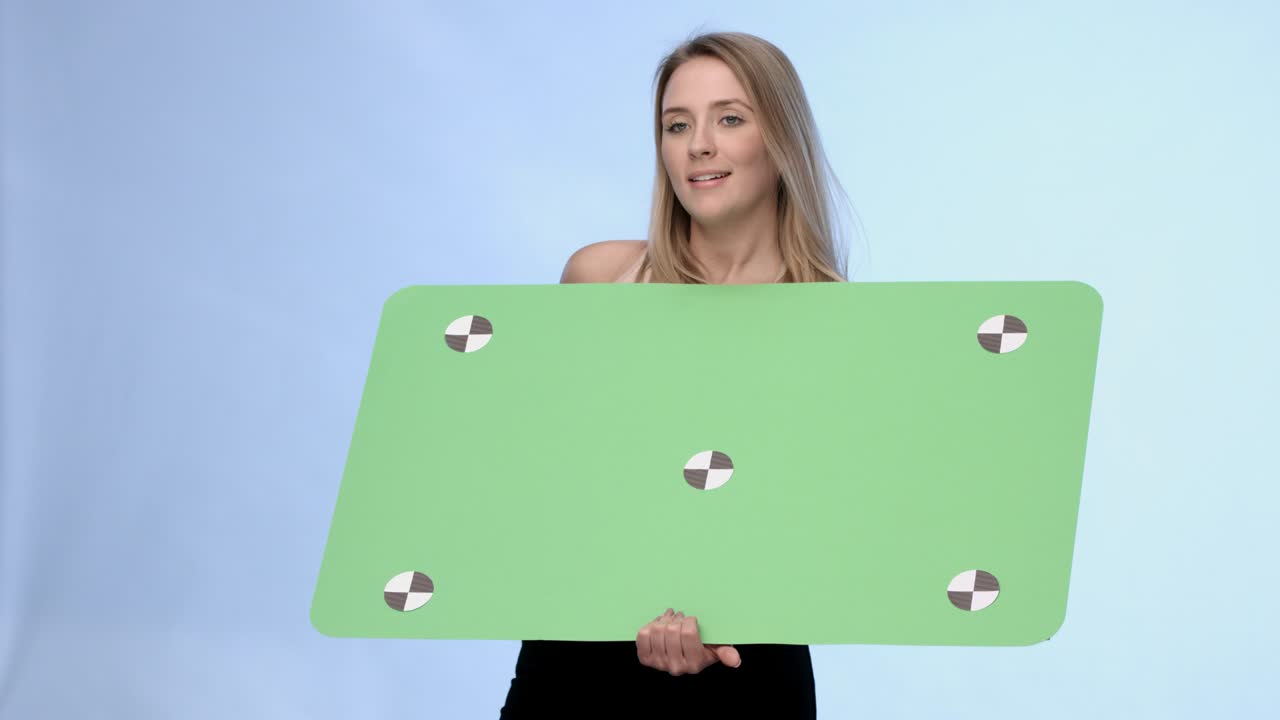 Beautiful blonde girl presenting oversized buisnesscard