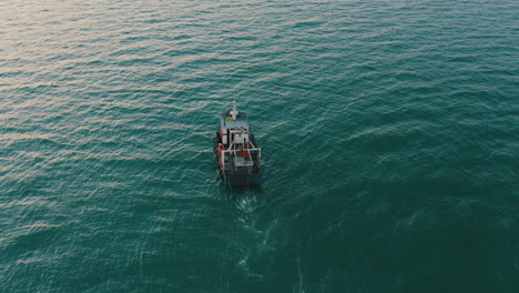 aerial 4k cinematic , fishing boat with nets in the water