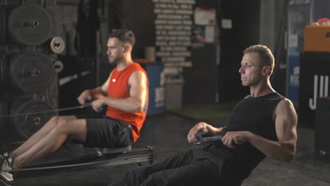 men rowing in gym