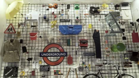 collection of everyday objects displayed on a wall, featuring london underground logo