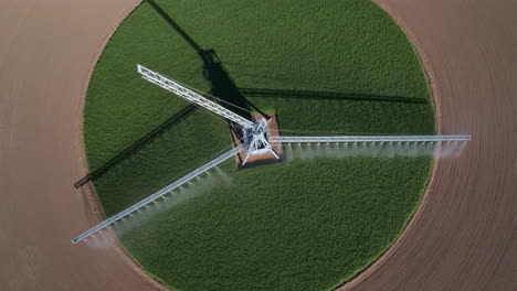 aerial view of a center pivot irrigation system watering a circular crop field