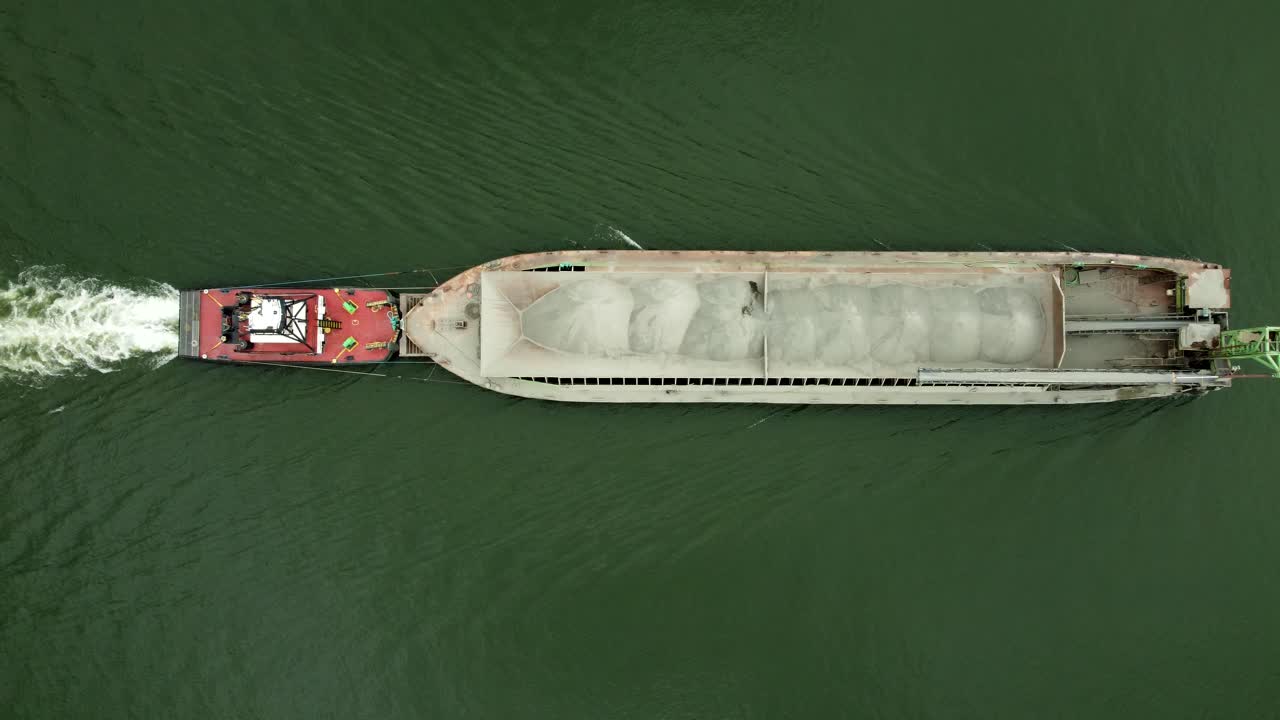 US, Oregon, Portland, St Johns, 2025-07-26 - Drone view of a barge being pushed by a tug on the Willamette River