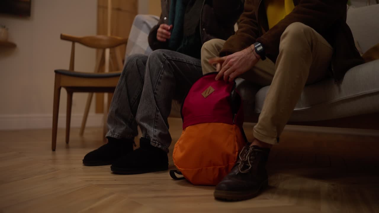 People Packing a Backpack at Home